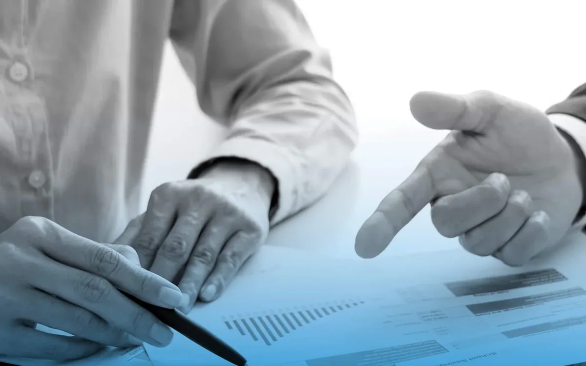 Wealth and investment discussion with an adviser, illustrating a careful portfolio review before switching funds